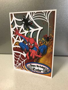 a spiderman birthday card on a table