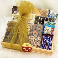 a wooden box filled with assorted snacks