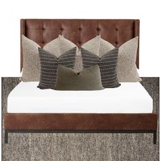 a bed with four pillows on top of it and a headboard made out of wood