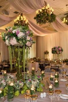 the centerpieces are decorated with flowers and greenery