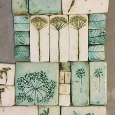 several tiles with different designs on them sitting next to each other in the shape of dandelions