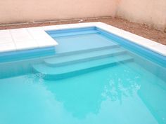 an empty swimming pool with steps leading up to it