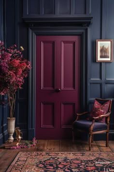 a purple door in a blue room with a chair next to it and flowers on the floor