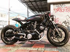 a black motorcycle parked in front of a building