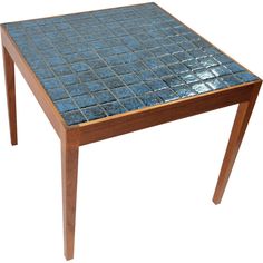 a blue tiled table with wooden legs