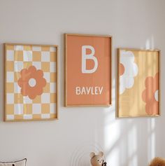 three framed pictures hang on the wall above a bed in a child's room