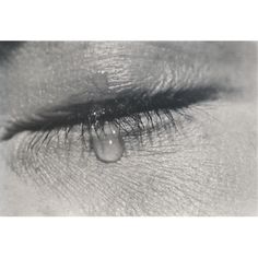 an eye with water drops coming out of the iris's lashes, in black and white