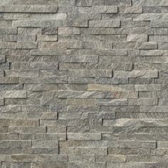 a stone wall that looks like it has been made out of grey and white bricks