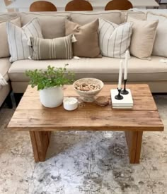 a living room with a couch, coffee table and pillows