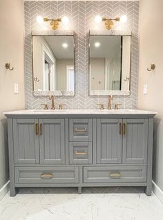 a bathroom vanity with two mirrors above it