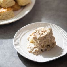 two white plates with biscuits on them next to each other