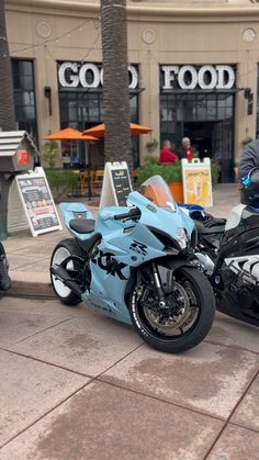 two motorcycles parked in front of a building