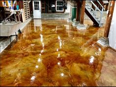 the floor is shiny and brown in this room with stairs leading up to an upper level