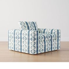 a blue and white chair sitting on top of a hard wood floor