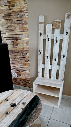 a wooden chair sitting next to a table