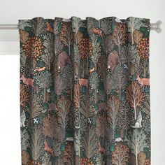 an animal themed curtain hanging on the side of a window