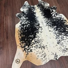 a cowhide rug with black and white spots