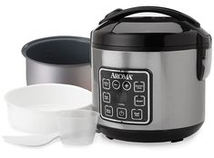 an electric pressure cooker with two bowls next to it