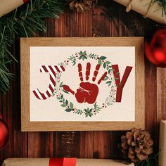 a christmas card with the word joy written in red and green on it, surrounded by holiday decorations