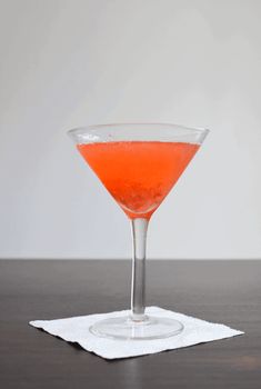 a drink in a coupe glass on a napkin