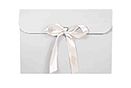 a white envelope with a bow tied around it