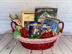 a basket filled with books and christmas decorations