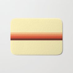 a bath mat with an orange and red stripe on it's side, in front of a white background