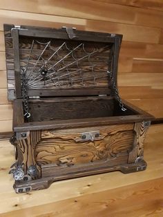 an old wooden chest with spider webs on it's sides and metal handles