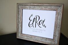 an ornate wooden frame with the word efrie in black and white lettering on it