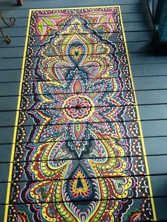 an artisticly designed rug is on the ground