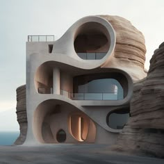 an unusual building made out of concrete on the side of a cliff overlooking the ocean