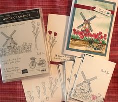 several cards with windmills and flowers on them