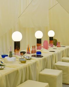 a long table is set up with white linens