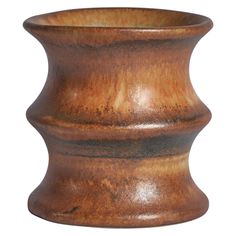 a brown vase is shown on a white background and it looks like it has been made out of wood