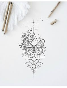 a drawing of a butterfly and flowers on a white paper next to crayons