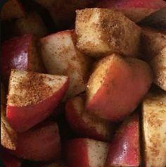 close up view of sliced apples with cinnamon on top and brown sugar on the side