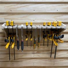 several tools are hanging on the wall with pegs