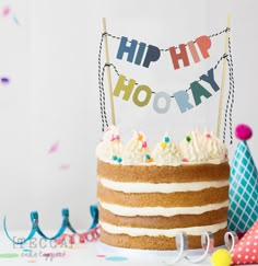 a birthday cake with the words hip hip hooray on it and decorations around it