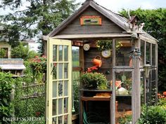 an outdoor garden shed with plants and flowers in it