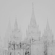 a black and white photo of a castle in the snow