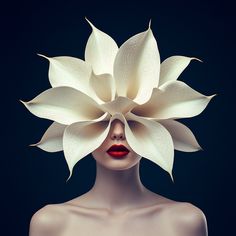 a woman with white flowers on her head and red lipstick in front of her face