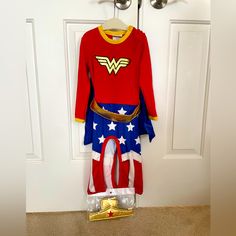 a red, white and blue costume hanging on a door