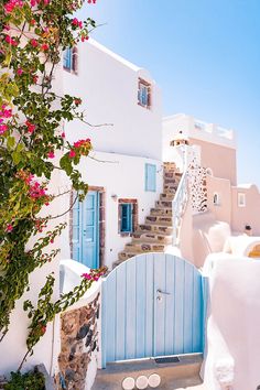 a white house with blue doors and stairs