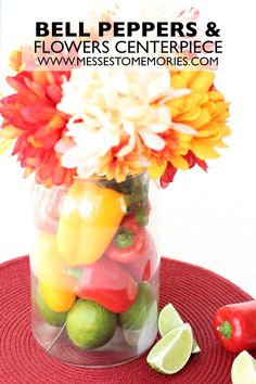 a vase filled with lots of different types of fruit and veggies on top of a red place mat