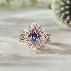 a pink and blue ring sitting on top of sand