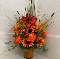 a vase filled with lots of flowers on top of a white countertop next to a wall