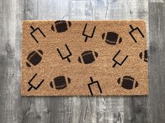 a door mat with footballs and crosses on it, sitting on a wooden floor