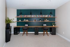 a home office with two desks and bookshelves