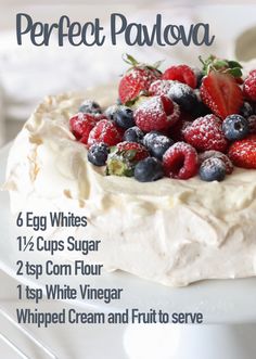 a white cake with berries and whipped cream on top is featured in the recipe for perfect pavvaa