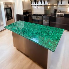 a green counter top in the middle of a kitchen